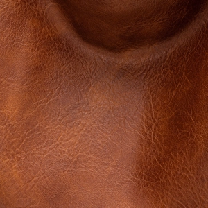 Macro shot showing the fine natural grain and rich texture of brown soft leather material