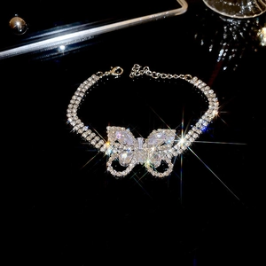 Detailed view of silver butterfly bracelet with sparkling zircon stones and double chains