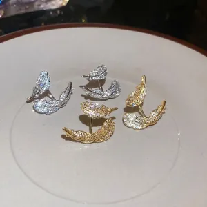 Elegant gold and silver plated feather stud earrings with sparkling cubic zirconia stones