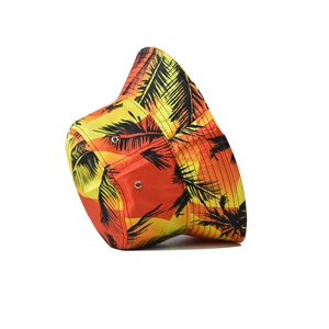 Detail of floral sunset gradient bucket hat with tropical black palm tree print pattern