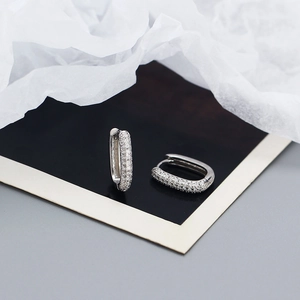 Macro detail of S925 sterling silver hoop earrings with micro-set cubic zirconia stones