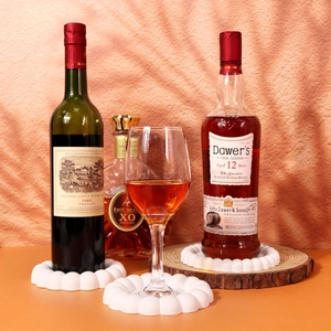 Close-up of wavy white silicone coaster pads used as anti-slip bottle and glass mats