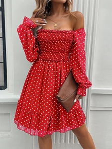 Detail of red polka dot off-shoulder dress with elastic smocking and ruffle sleeves