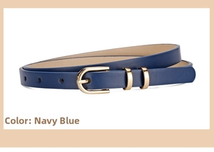 Close-up of navy blue skinny leather belt with polished gold buckle for summer dresses