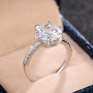 Macro shot of a classic six-prong zirconia engagement ring in a beige jewelry box
