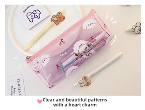 Close-up of pink transparent pencil case with cartoon dog pattern and heart pendant
