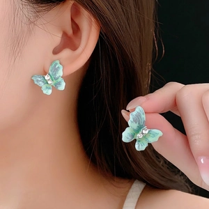 Vintage butterfly earrings with mint green marble texture and sparkling crystal accents