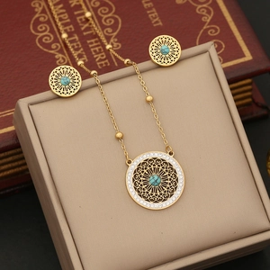Golden necklace and stud earrings set with turquoise center and sparkling crystals