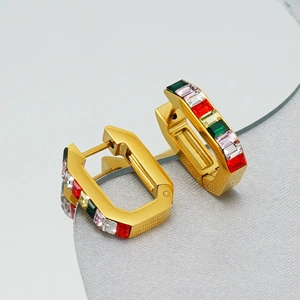 Macro view of gold rectangle earrings with colorful baguette-cut cubic zirconia stones
