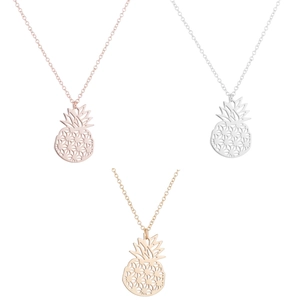 Detailed view of hollow pineapple pendant necklaces in rose gold, silver, and gold finishes