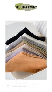 Detailed texture of combed cotton socks in various Morandi colors on white tray