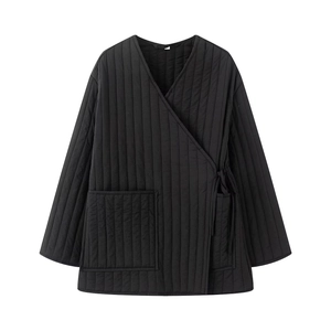 Detail of black quilted cotton jacket with kimono collar and tie closure design