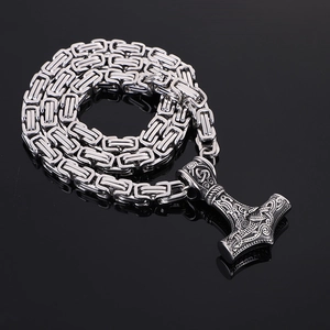 Macro view of polished silver Byzantine chain with detailed Viking Mjolnir hammer pendant