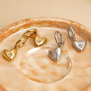 Polished stainless steel heart drop earrings in gold and silver with starburst engraving