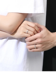 Close-up of S925 silver couple rings featuring a heart stone and twisted rope texture