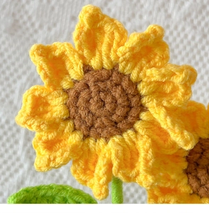Close-up of hand-knitted sunflower with detailed crochet texture and vibrant yarn petals
