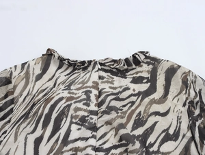 Detail view of chiffon tiger print dress back with ruffled collar and invisible zipper