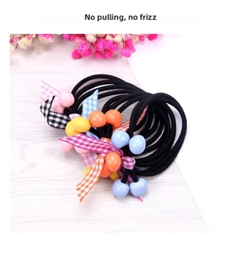 Close-up of elastic hair ties with colorful frosted beads and plaid ribbon bows