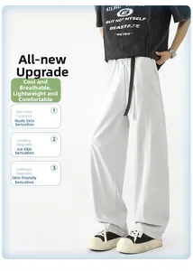 Detalle de pantalones anchos gris claro que muestra tela fresca, transpirable y caída