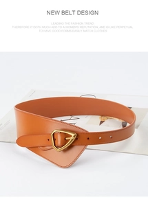 Macro view of orange leather corset belt featuring a stylish gold triangle metal buckle