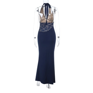 Detail view of the back of a navy blue evening gown with lace patchwork and halter neck