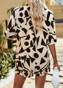 Rear view of woman in casual white and black geometric print shirt and shorts set