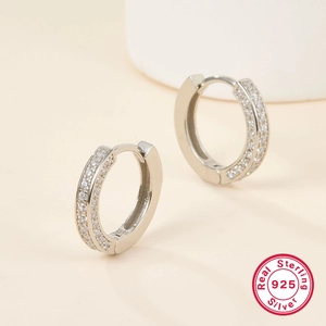 Close-up of S925 sterling silver hoop earrings with double-row white cubic zirconia