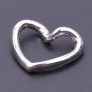 Macro shot of polished silver heart charm in stainless steel for jewelry making