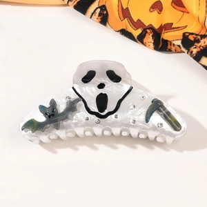 Detailed view of Halloween hair claw with ghost face, bat and sparkling rhinestones
