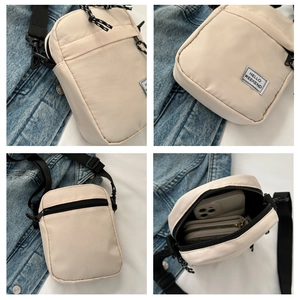 Detail view of beige crossbody bag showing interior capacity and HELLO WEEKEND patch