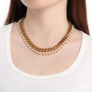Detail view of 9mm golden Cuban chain necklace with delicate white pearl pendants