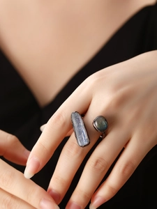 Detail of vintage bronze adjustable ring featuring raw kyanite and labradorite stones