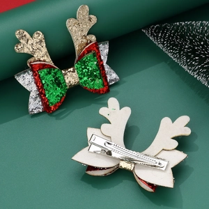 Detail of Christmas reindeer bow hair clip with glitter finish and metal duckbill attachment