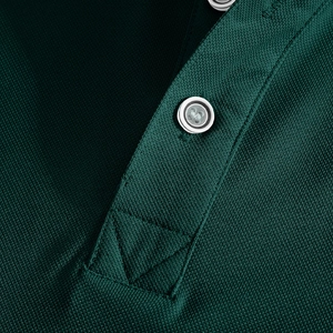Detailed close-up of dark green polo shirt collar with white buttons and pique fabric
