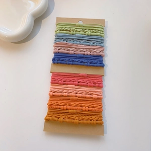 Detailed set of multi-colored textured elastic hair ties on brown cardboard cards