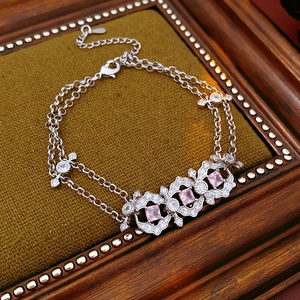 Detail of vintage silver bracelet with pink zircon stones on olive green velvet