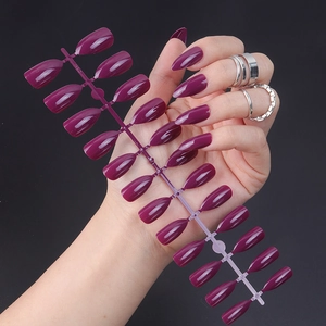 Detail of dark purple glossy stiletto press-on nails set with 24 pieces in various sizes