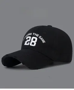 Detail of distressed brim and 3D embroidered number 28 on a black cotton baseball cap