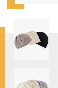 Detailed close-up of soft knitted beanies in various neutral colors with tight weave texture