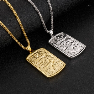 Detail of gold and silver rectangular skull and crossbones pendants on metal chains