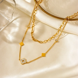 Double-layer gold titanium steel necklace with sparkling zircon clover pendants on white silk