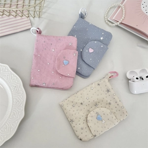 Close-up of star pattern fabric coin purses with heart buttons and plastic carabiners
