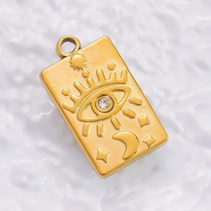 Detailed view of a gold tarot card pendant with embossed sun, moon and zircon inlay