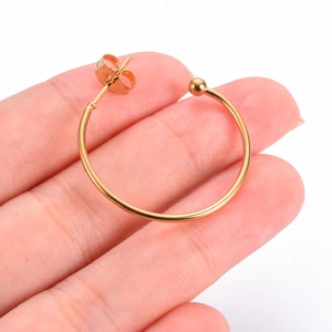 Polished gold stainless steel C-shaped hoop earring with ball end and secure back