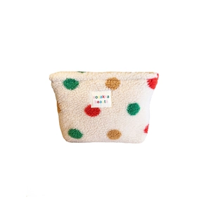 White plush fleece makeup bag with colorful polka dots and rectangular label