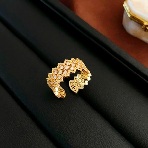 Detail of gold open ring with zigzag pavé setting and sparkling cubic zirconia stones