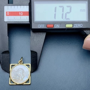 Detailed measurement of golden square angel pendant with white shell showing 17.2 mm size