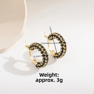 Detail of gold huggie earrings with triple-row black zircon stones and size specs