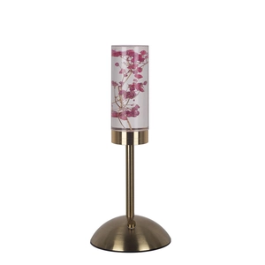 Detail of creative acrylic night light with pink preserved flowers on a golden metal base