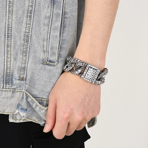 Close-up of vintage stainless steel snake chain bracelet with hammered texture on wrist